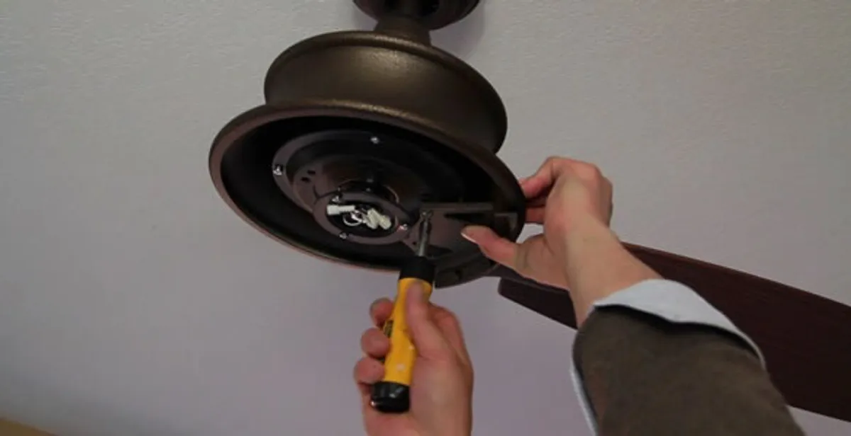 Electrician installing ceiling fan mounting bracket and fixture in Easton, PA