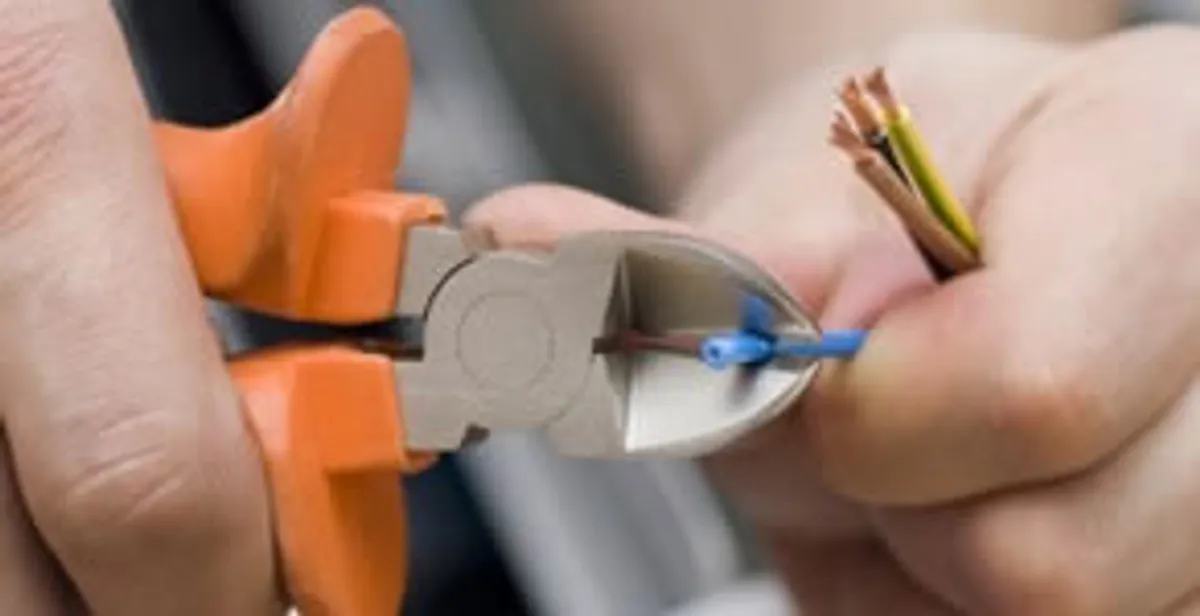 licensed electrician performing precise wire cutting and preparation during electrical service in Easton, PA